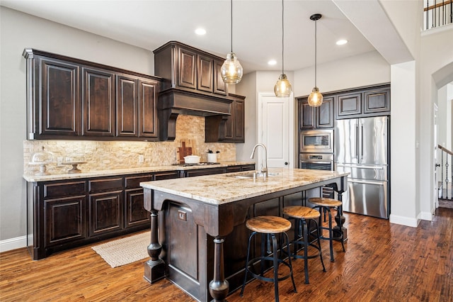 908 Champions Ct, Roanoke, TX 76262 - kitchen featuring stainless steel appliances, a sink, baseboards, light stone counters, and recessed lighting
