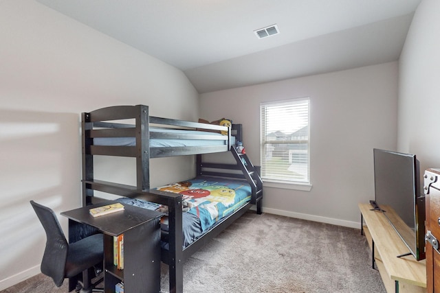 bedroom featuring visible vents, carpet floors, baseboards, and vaulted ceiling