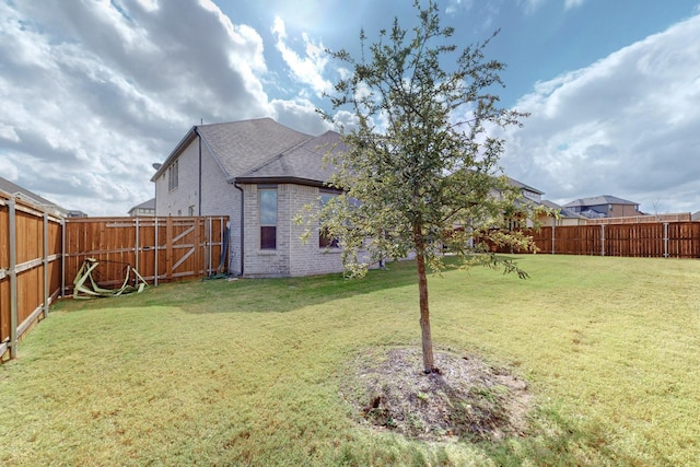 view of yard with a fenced backyard
