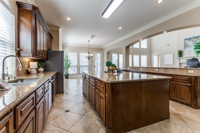 1217 Avondale Dr, Murphy, TX 75094 - kitchen featuring a sink, a center island, ornamental molding, a chandelier, and recessed lighting