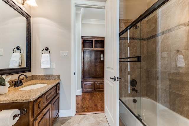 1217 Avondale Dr, Murphy, TX 75094 - full bathroom featuring vanity, shower / bath combination with glass door, crown molding, and baseboards