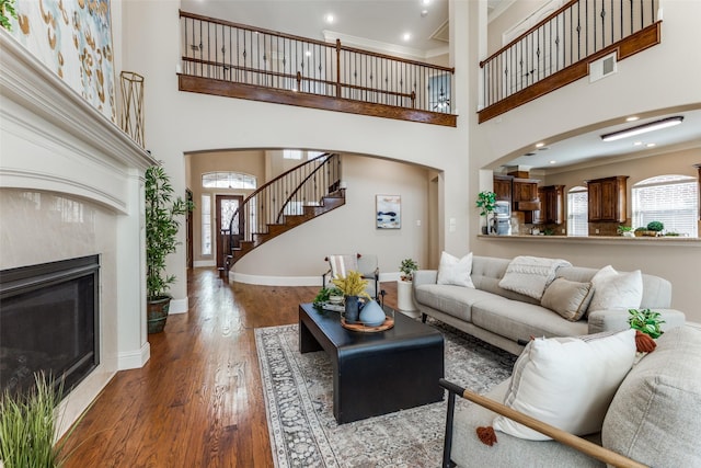 1217 Avondale Dr, Murphy, TX 75094 - living room with wood finished floors, arched walkways, crown molding, stairway, and baseboards