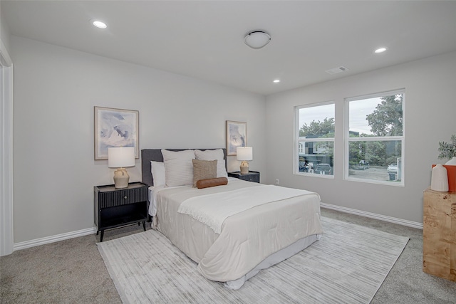 bedroom featuring baseboards, light carpet, and recessed lighting