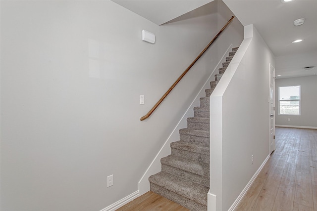 stairs featuring baseboards, recessed lighting, and wood finished floors
