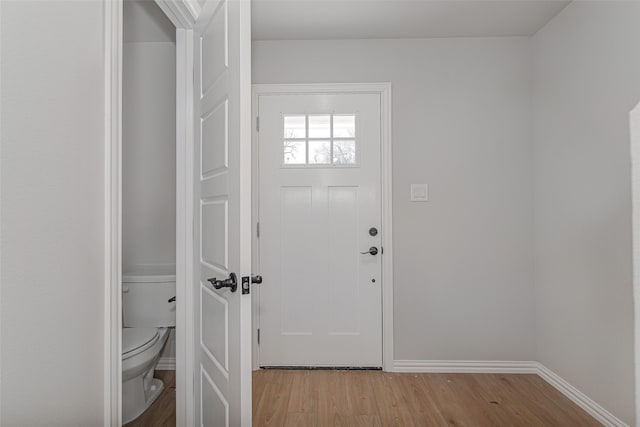 foyer entrance with baseboards and light wood finished floors