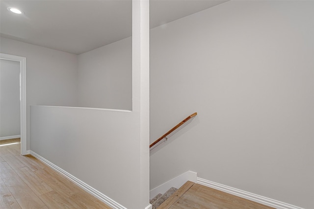 stairs with baseboards, recessed lighting, and wood finished floors