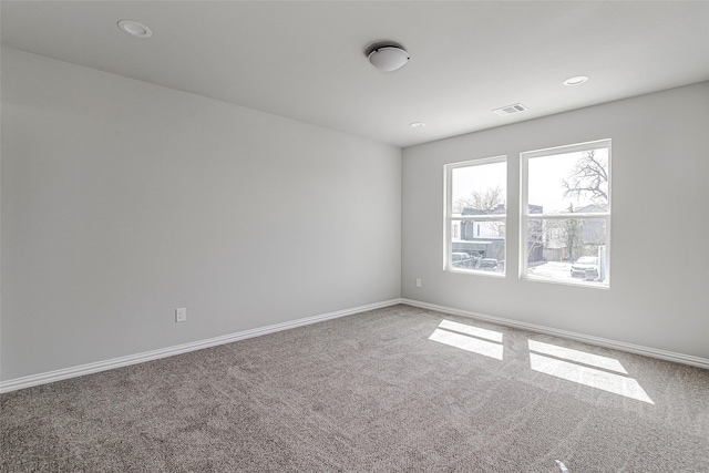 carpeted empty room with recessed lighting, baseboards, and visible vents