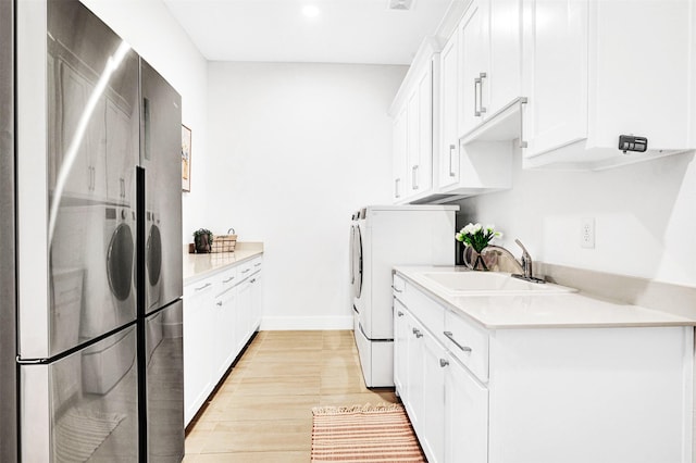 4909 Cheshire Ln, Parker, TX 75002 - kitchen with light countertops, white cabinetry, a sink, washer and dryer, and freestanding refrigerator