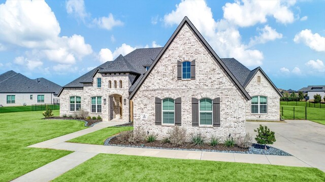 4909 Cheshire Ln, Parker, TX 75002 - french country home with brick siding, fence, and a front yard