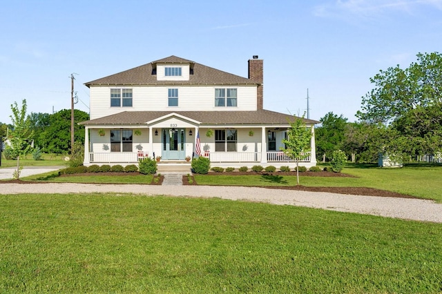 view of front of property with a chimney, a front yard, a shingled roof, and covered porch
