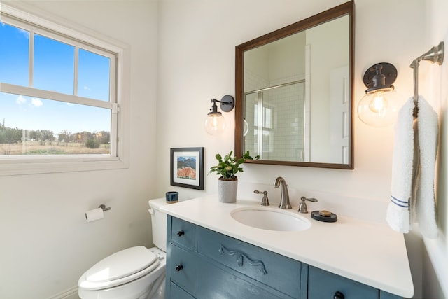 full bath with toilet, an enclosed shower, and vanity