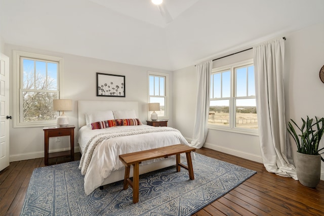 bedroom featuring hardwood / wood-style flooring, baseboards, and multiple windows