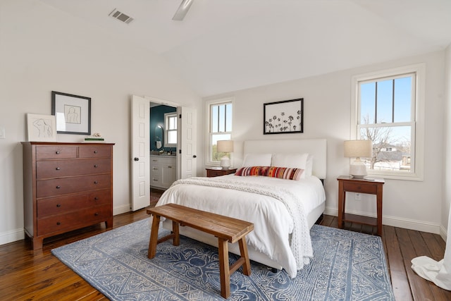 bedroom featuring lofted ceiling, baseboards, visible vents, and hardwood / wood-style floors