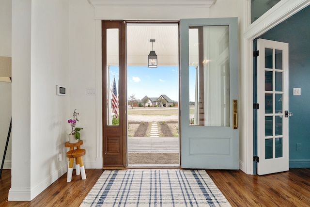 entrance foyer featuring wood finished floors and baseboards