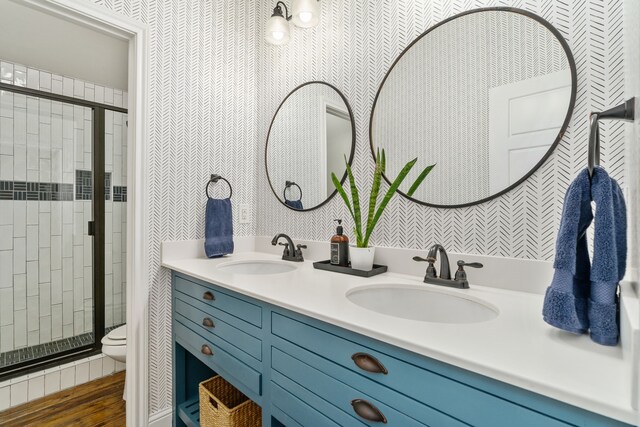 full bath featuring a shower stall, toilet, and a sink