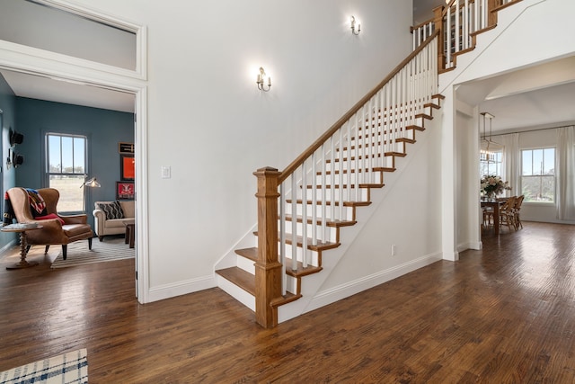 staircase featuring baseboards and wood finished floors