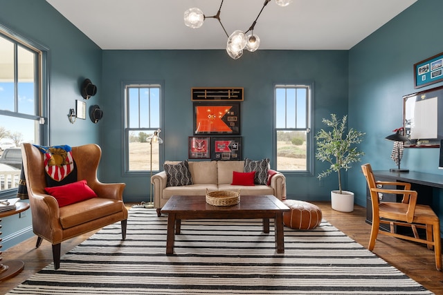 living area with wood finished floors, a healthy amount of sunlight, and baseboards