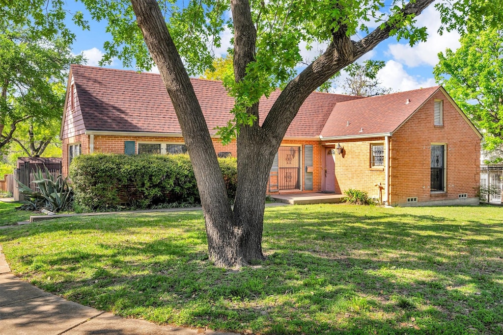 7003 Lindsley Ave, Dallas, TX 75223 - view of front facade with a wooden deck, fence, a front lawn, and brick siding