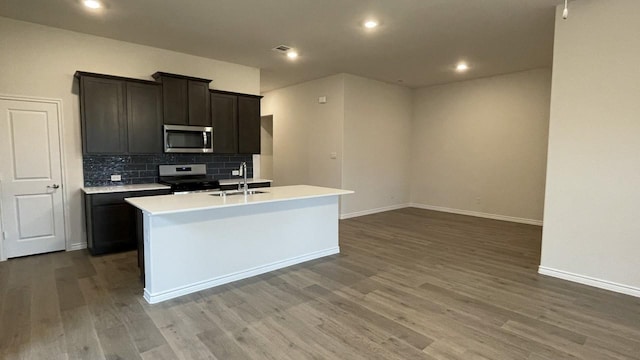 4165 Plateau Dr, Forney, TX 75126 - kitchen featuring wood finished floors, decorative backsplash, a sink, and stainless steel appliances