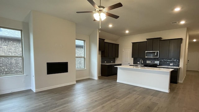 4165 Plateau Dr, Forney, TX 75126 - kitchen with a healthy amount of sunlight, ceiling fan, appliances with stainless steel finishes, and decorative backsplash