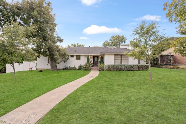 single story home with a front yard and fence