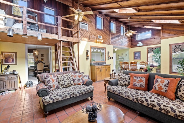 living area featuring wood ceiling, lofted ceiling with beams, tile patterned flooring, visible vents, and ceiling fan