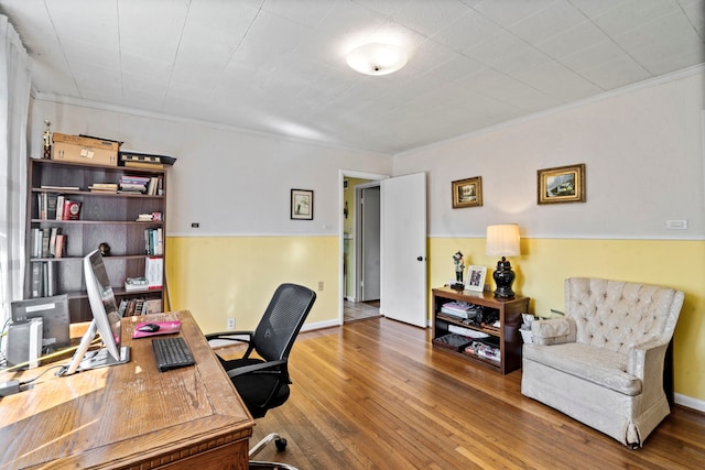 office area with baseboards, crown molding, and wood finished floors