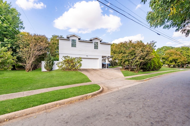 view of front of property featuring a front lawn, fence, driveway, and an attached garage