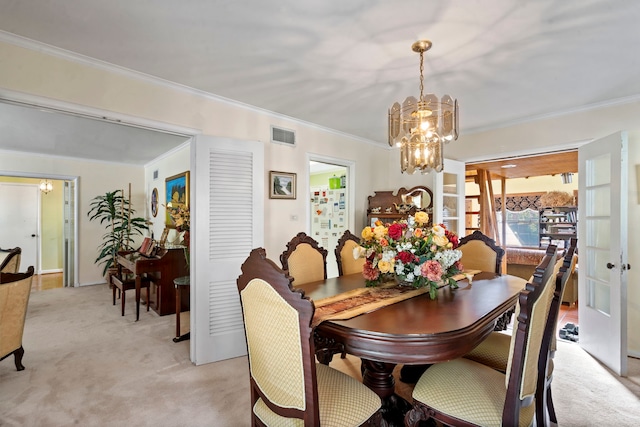 dining area featuring an inviting chandelier, crown molding, and light colored carpet