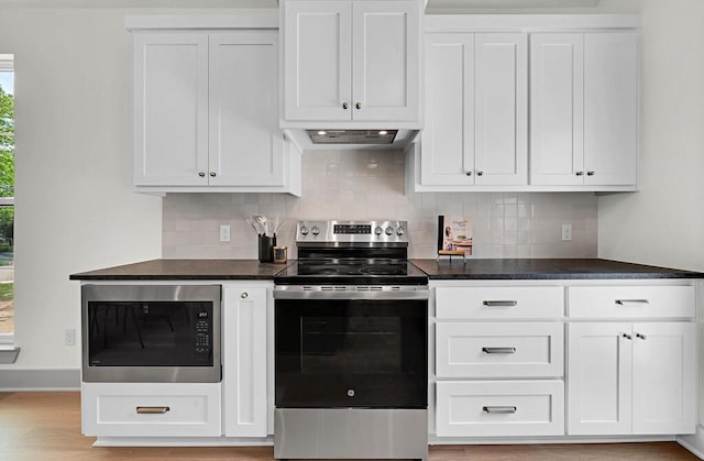 538 Proctor Ave, Waco, TX 76708 - kitchen with appliances with stainless steel finishes, dark countertops, tasteful backsplash, and white cabinetry