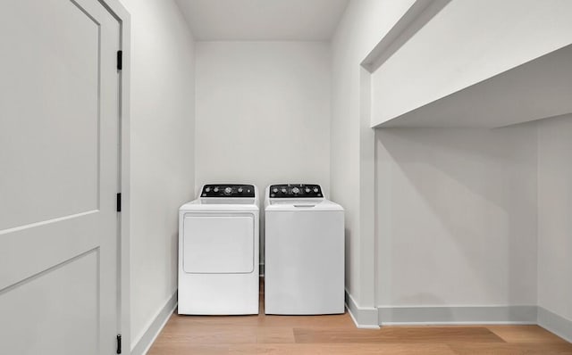 538 Proctor Ave, Waco, TX 76708 - washroom featuring washer and clothes dryer, light wood-style flooring, and baseboards