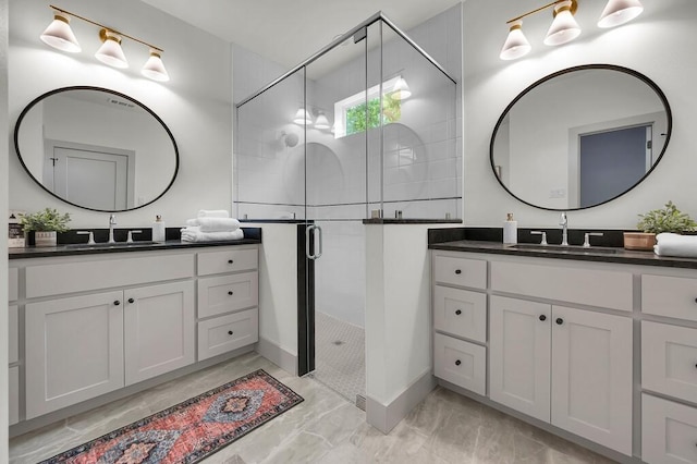 538 Proctor Ave, Waco, TX 76708 - full bathroom with a shower stall, two vanities, marble look tiles, and baseboards