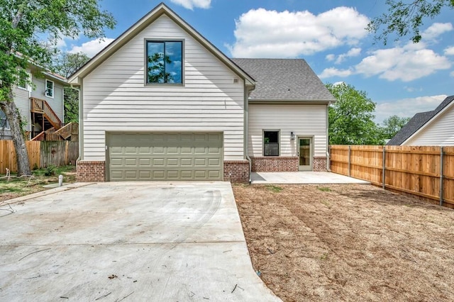 538 Proctor Ave, Waco, TX 76708 - view of front of property featuring brick siding, an attached garage, driveway, and fence