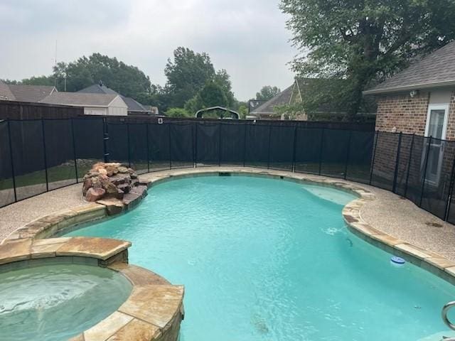 1108 Regent Ln, Greenville, TX 75402 - view of swimming pool with a fenced backyard and a pool with connected hot tub