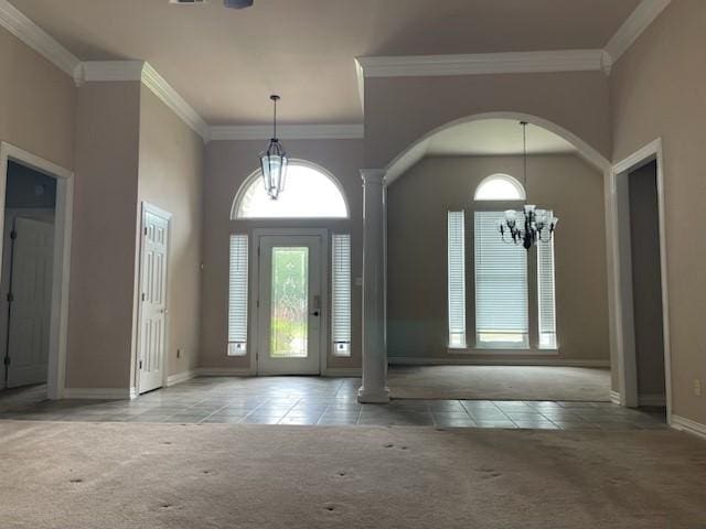 1108 Regent Ln, Greenville, TX 75402 - tiled foyer entrance with carpet floors, baseboards, crown molding, arched walkways, and a chandelier