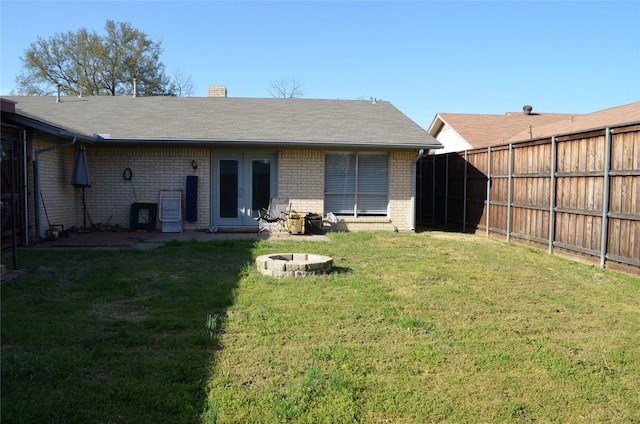 1034 Holland Dr, Garland, TX 75040 - back of house featuring brick siding, fence, french doors, and a yard