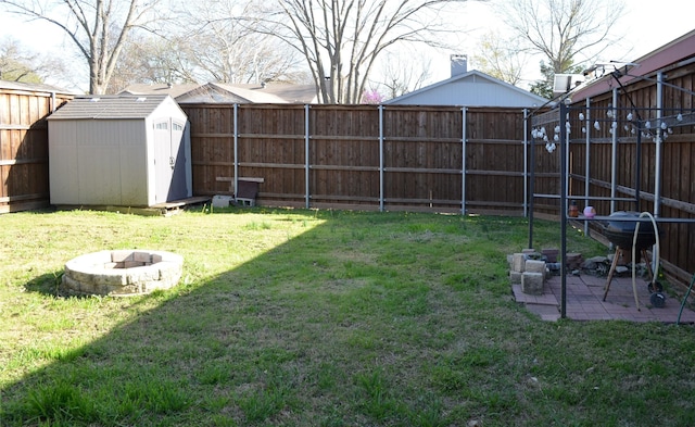1034 Holland Dr, Garland, TX 75040 - view of yard with a fire pit, a patio area, an outdoor structure, a fenced backyard, and a storage unit
