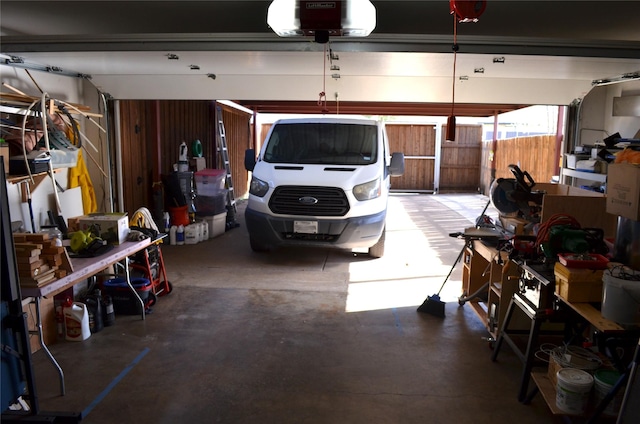 1034 Holland Dr, Garland, TX 75040 - garage with a workshop area and a garage door opener