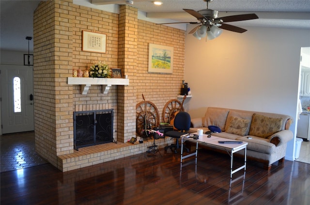 1034 Holland Dr, Garland, TX 75040 - living area featuring a textured ceiling, ceiling fan, a brick fireplace, and hardwood / wood-style flooring