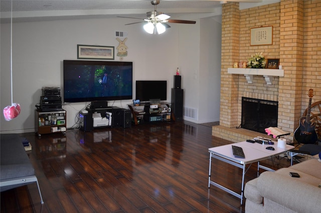 1034 Holland Dr, Garland, TX 75040 - living area with visible vents, a brick fireplace, wood finished floors, a ceiling fan, and vaulted ceiling
