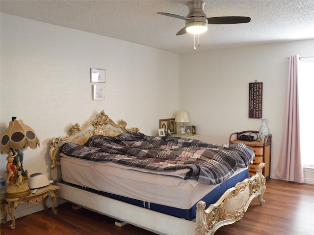 1034 Holland Dr, Garland, TX 75040 - bedroom featuring a textured ceiling, wood finished floors, multiple windows, and a ceiling fan