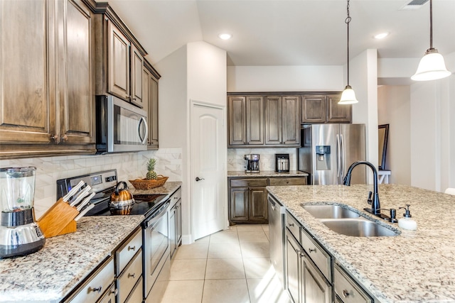 5928 Dunnlevy Dr, Fort Worth, TX 76179 - kitchen featuring light stone counters, light tile patterned flooring, a sink, and stainless steel appliances