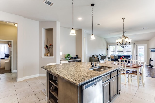 5928 Dunnlevy Dr, Fort Worth, TX 76179 - kitchen with stainless steel dishwasher, open floor plan, a sink, and light tile patterned flooring