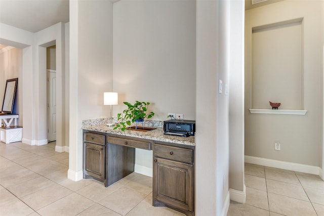 5928 Dunnlevy Dr, Fort Worth, TX 76179 - interior space featuring light tile patterned floors, built in study area, and baseboards