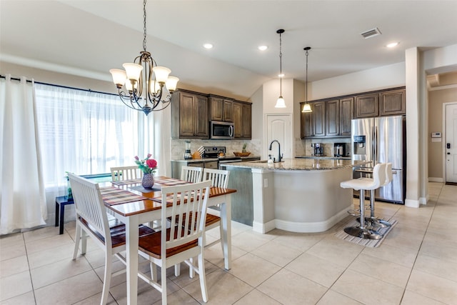 5928 Dunnlevy Dr, Fort Worth, TX 76179 - kitchen with tasteful backsplash, dark brown cabinets, visible vents, a chandelier, and appliances with stainless steel finishes