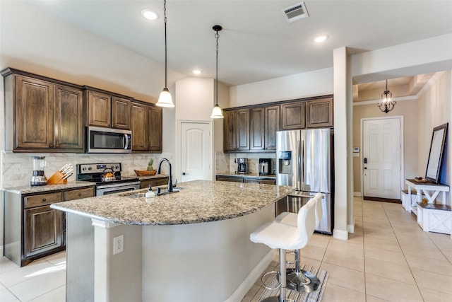 5928 Dunnlevy Dr, Fort Worth, TX 76179 - kitchen with light tile patterned floors, visible vents, appliances with stainless steel finishes, a sink, and backsplash