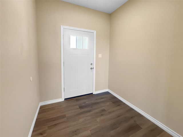 foyer with baseboards and dark wood-style flooring