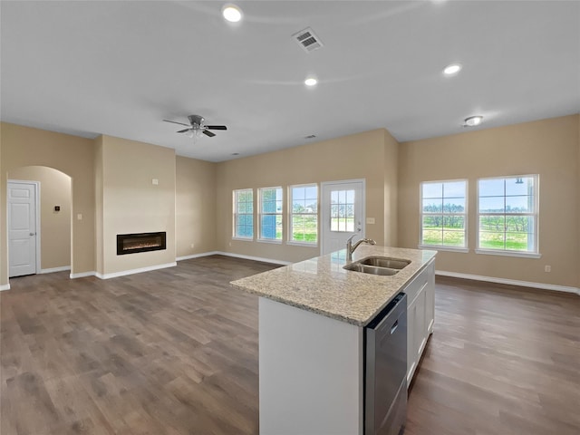 kitchen with visible vents, a sink, stainless steel dishwasher, and open floor plan