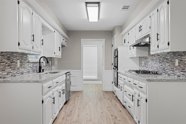 1206 Mayapple Dr, Garland, TX 75043 - kitchen featuring white cabinets, visible vents, appliances with stainless steel finishes, under cabinet range hood, and light wood-style floors