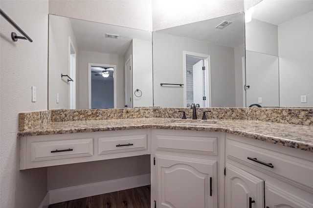 1206 Mayapple Dr, Garland, TX 75043 - bathroom with visible vents, wood finished floors, ceiling fan, and vanity